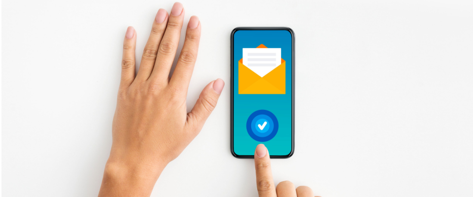 Person using a smartphone to submit renters insurance claims, featuring a digital envelope and verification checkmark on the screen.