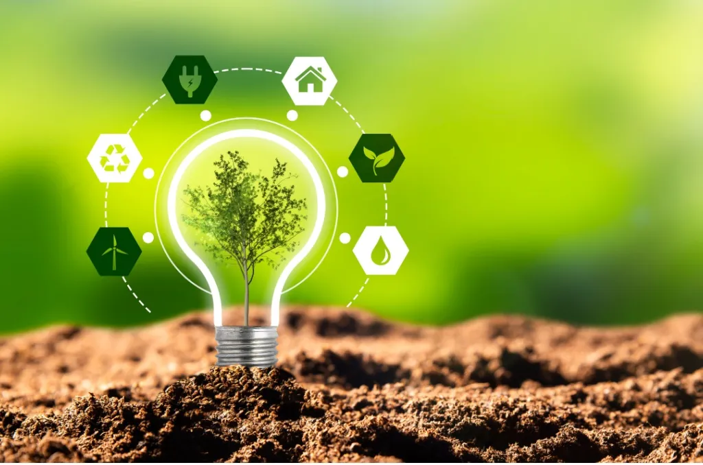 Illustration of renewable versus nonrenewable resources featuring a light bulb with a tree growing inside it, surrounded by renewables icons such as solar power, wind power, and hydropower.