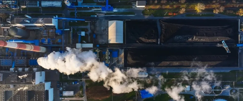 Aerial view of a coal power plant emitting smoke, showcasing the environmental impact of nonrenewable energy sources and raising questions about sustainable alternatives.