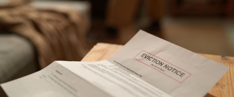 Close-up of an eviction notice document, illustrating situations where renters insurance doesn't cover displacement and temporary housing costs.