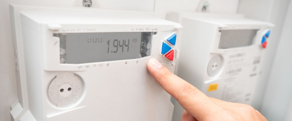 Person pressing a button on a digital electric meter and learning how to read it  correctly.