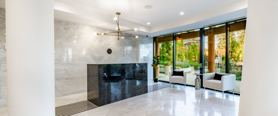 Modern apartment lobby with secure entry and floor-to-ceiling windows, reflecting renter safety tips for choosing a safe building.